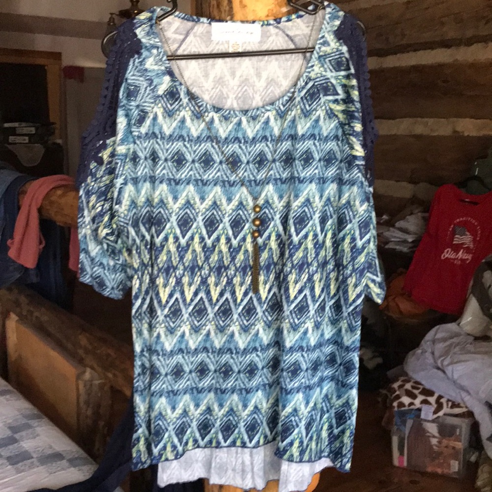 100% Polyester, soft, flowy blouse.